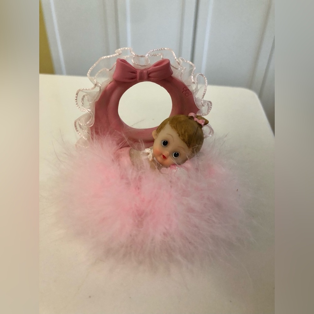 Baby small doll in a pink feather bassinet or pacifier holder figurine